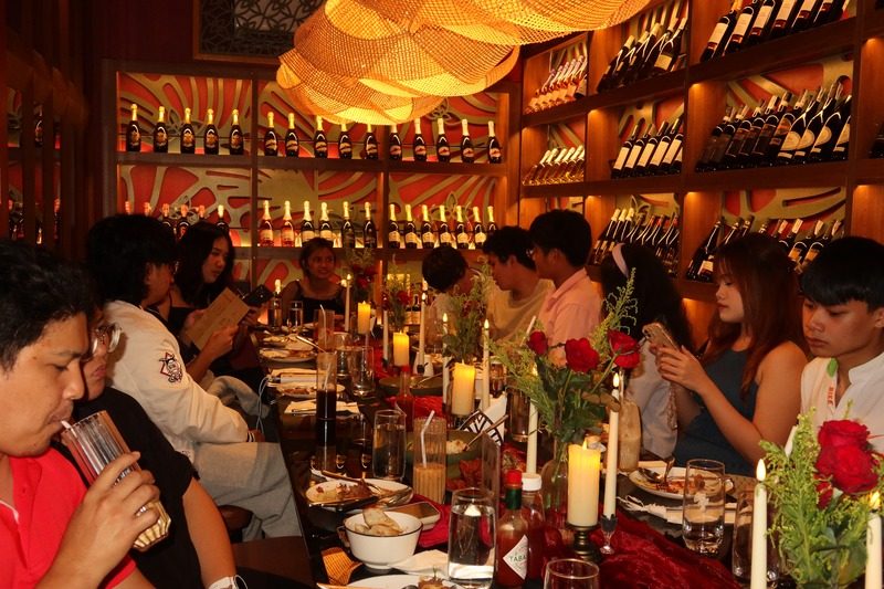 Guests dining under warm pendant lights