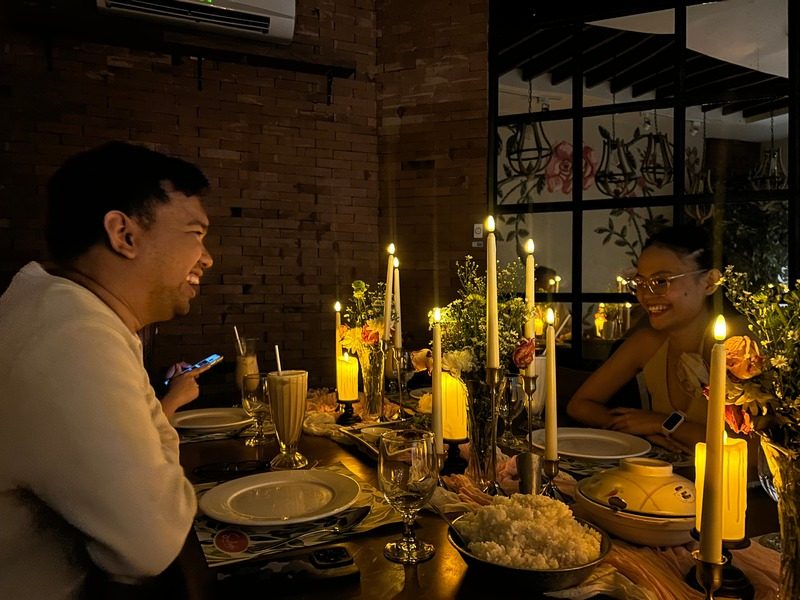 Diners at a candlelit table