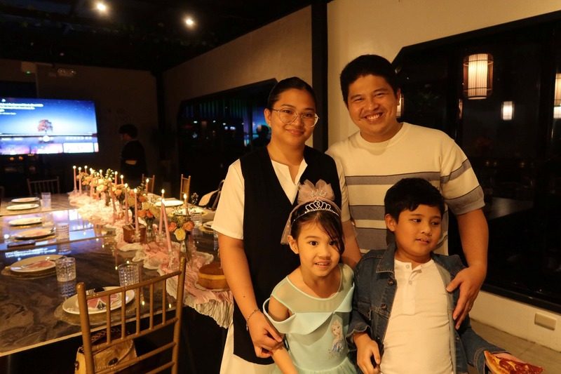 Family portrait beside a dressed table
