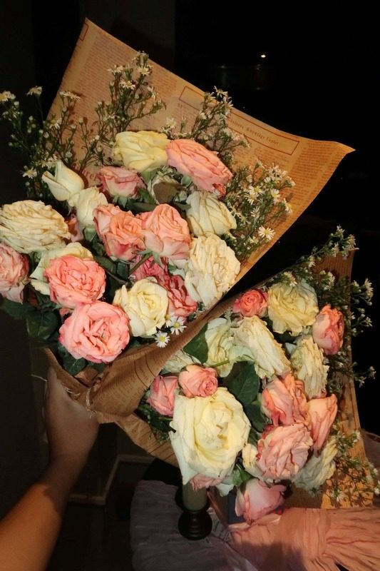 Bouquet of pink and white roses in kraft wrap