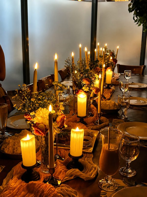 Candles glowing along a dressed table