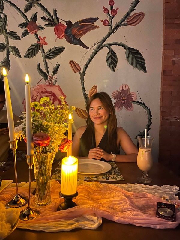 Guest seated at a candlelit table