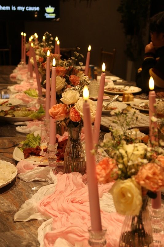Pink candles and florals on a long table