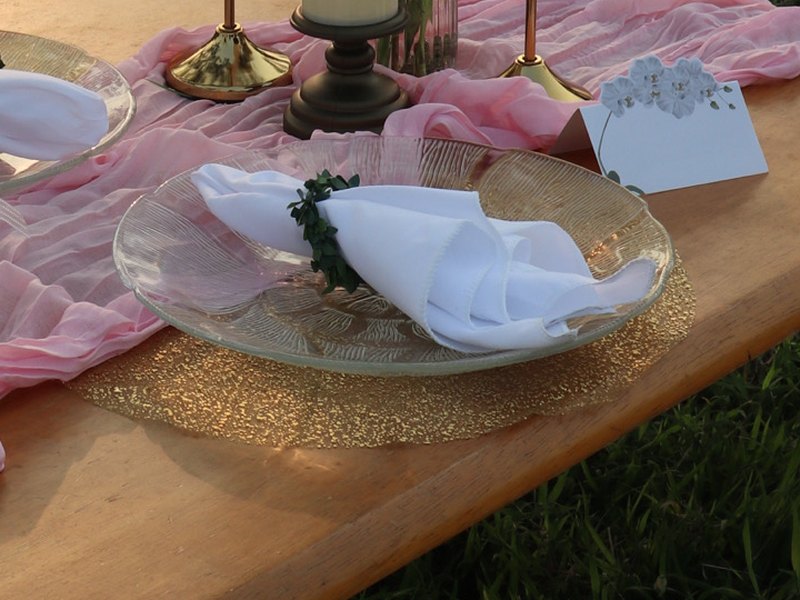 Sheer gold placemat under a glass plate